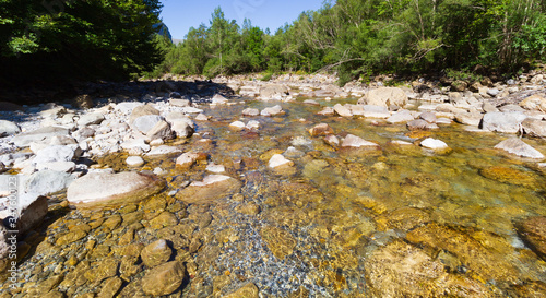 a mountain river with boulders and clear water
