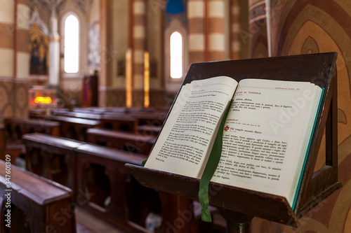 Open Bible on the stand inside San Lorenzo Cathedral (aka Duomo) in Alba, Italy.