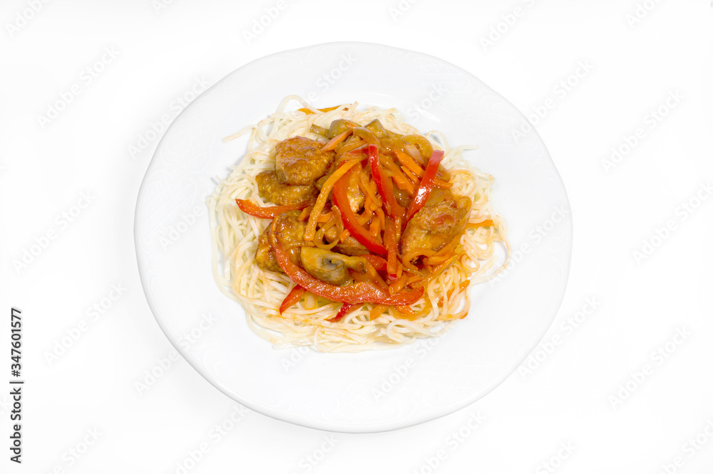 Boiled noodles with gravy of vegetables, chicken breast and mushrooms on a white plate on a white background