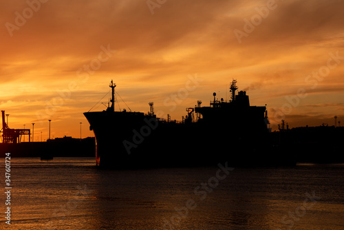 Profile of a tanker ship at sunset.