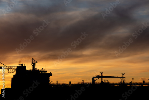 Silhouette of an oil tanker at sunset.