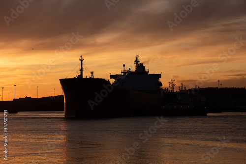 Silhouette of an oil tanker at sunset.