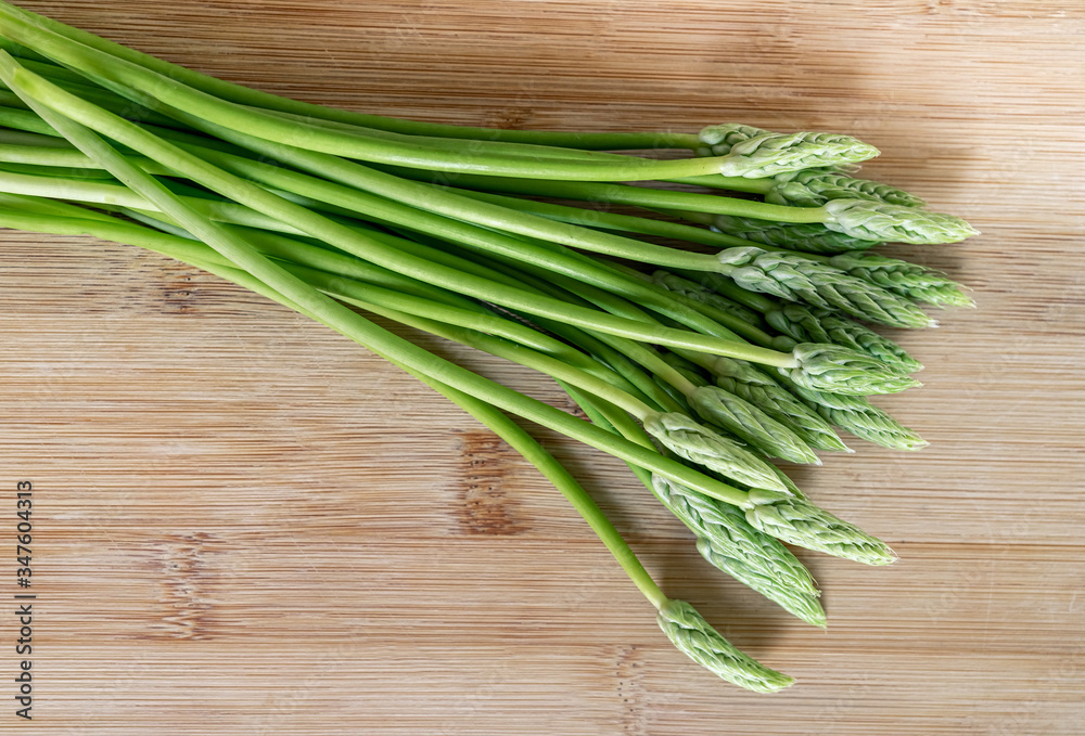 Fresh wild asparagus on a wooden background ready to be cooked Fresh wild asparagus on a wooden background ready to be cooked