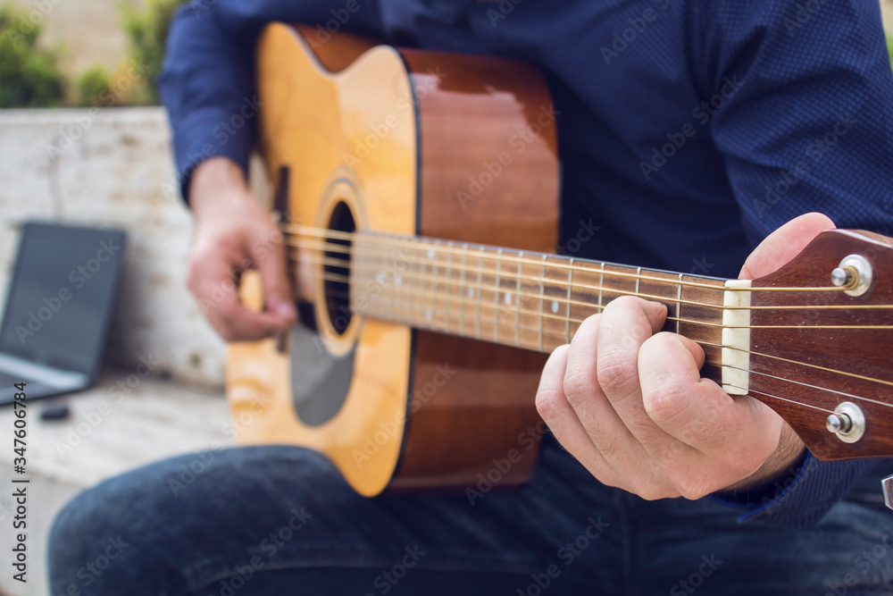 Fototapeta premium Young guy plays guitar