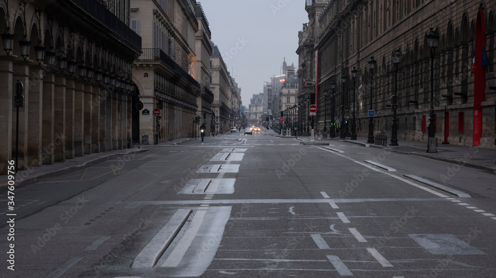 Fototapeta premium Paris, France, May 10th 2020. COVID-19 : Before easing the lockdown. Rue de Rivoli end of the last day of quarantine. The storm is coming. The main street will soon be prohibited to cars.