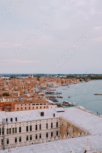 The ferry pier and mooring place for gondolas - San Marco-San Zaccaria in Venice, Italy. Aerial view from huge cathedral bell tower Saint Mark Campanile, View through the Doge's Palace.. © Nadtochiy