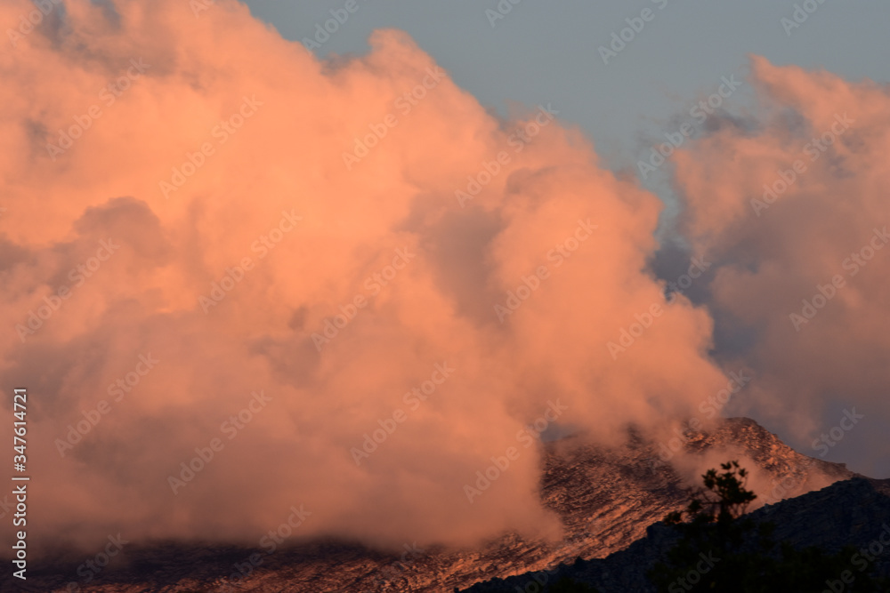 Cotton candy clouds over the mountain