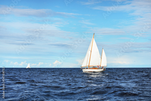 Billede på lærred Old expensive vintage wooden sailboat (yawl) close-up, sailing in an open sea