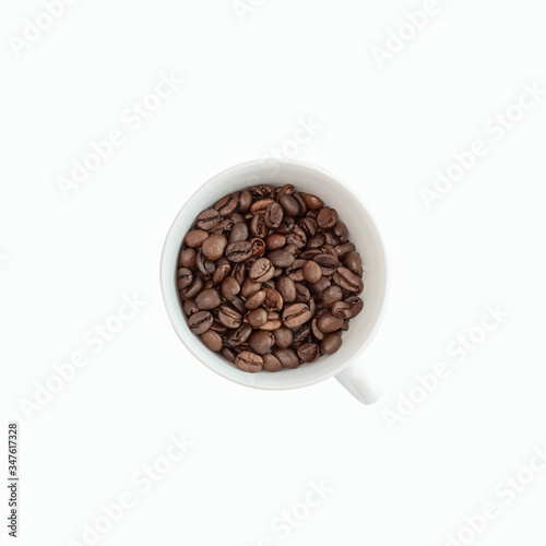 Coffee cup filled with coffee beans isolated on white