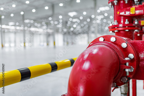 fire suppresion system in a empty industrial hall red pipes and bariers photo