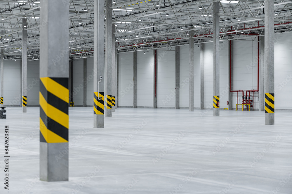 Clean and empty industrial hall in detail for supporting poles