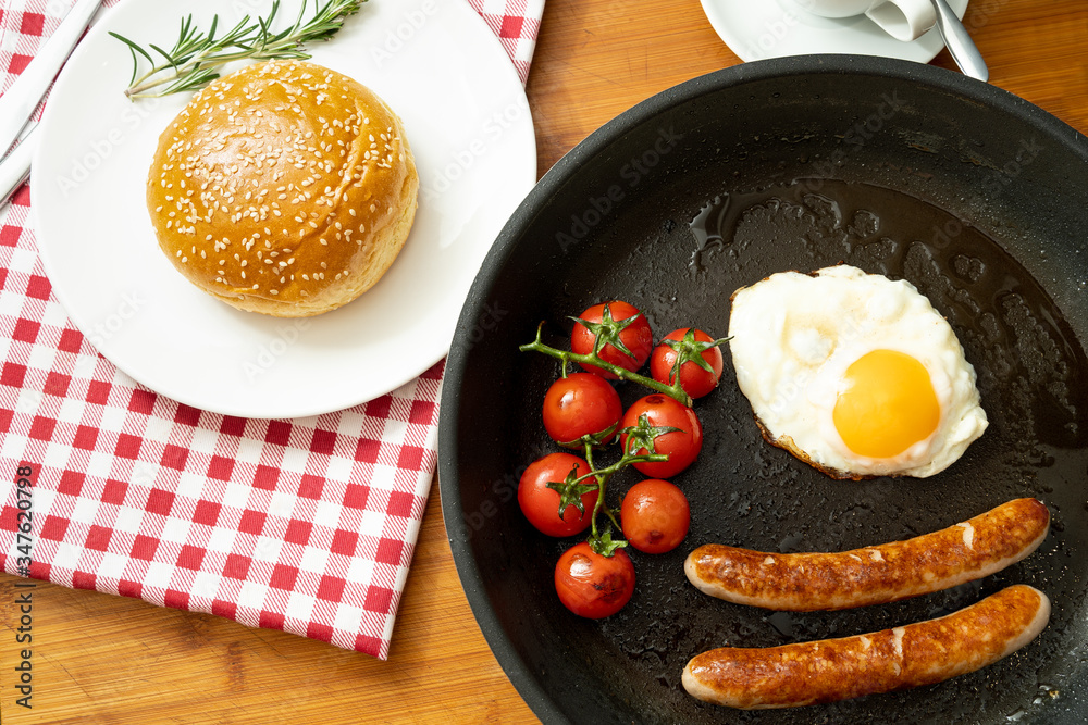overhead shot of fried breakfast American sausage egg tomatoes roll coffee quick tasty first healthy big portion