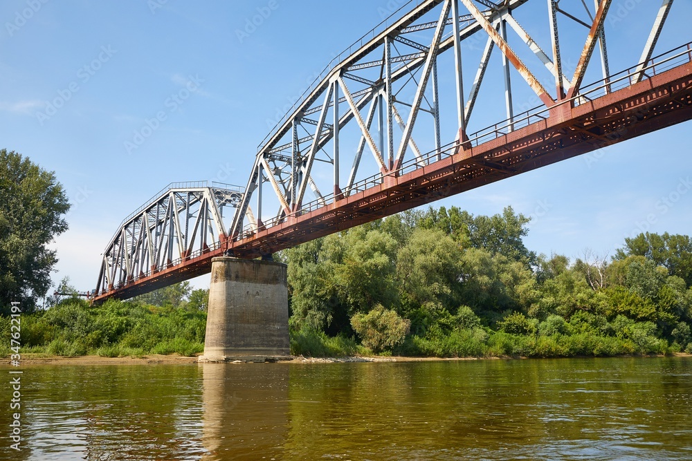 Old railway bridge over a river, rusty metal grid Old railway bridge over a river, rusty metal grid
