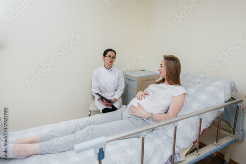 The doctor advises and serves a young pregnant girl in a medical clinic. Medical examination