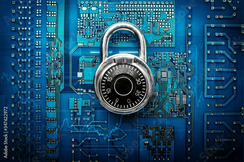 Code-locked padlock on circuit board. Fee Computer - computer security system. Top view
