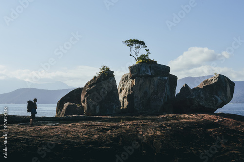 backpacker man looking at paradise landscape in Brazilian coasts of the Atlantic Ocean 