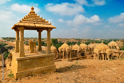 Tourist attraction and Rajasthan landmark - Bada Bagh cenotaphs (Hindu tomb mausoleum) made of sandstone in Indian Thar desert. Jaisalmer, Rajasthan, India photo