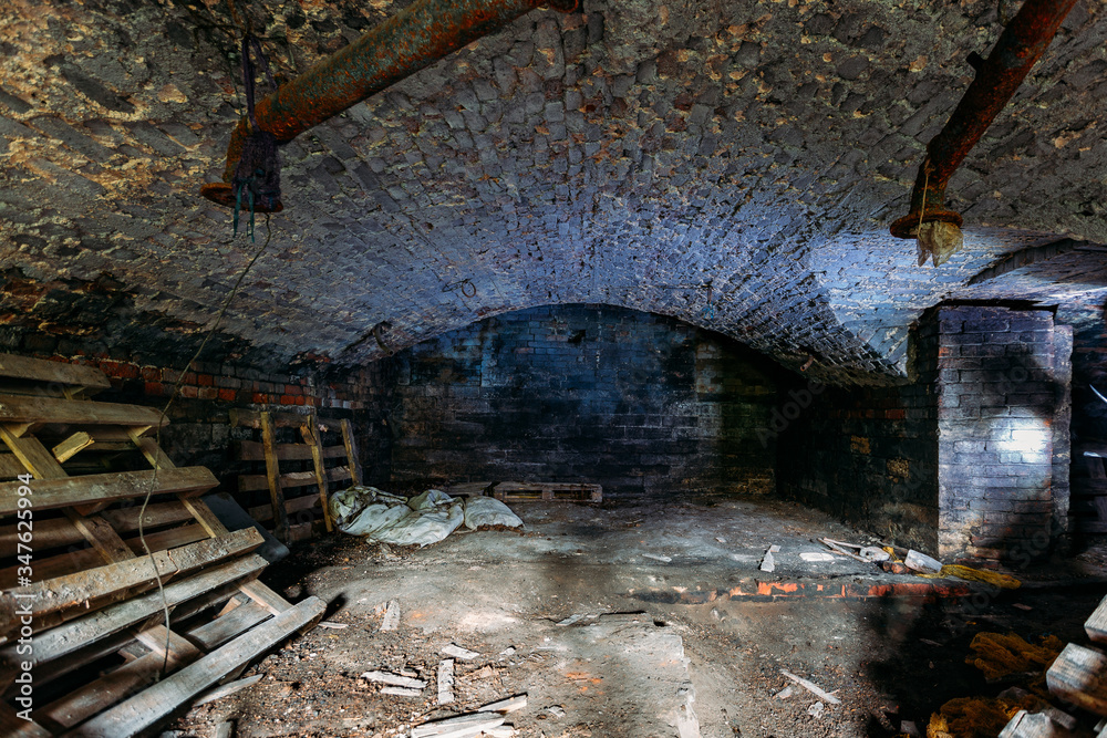 Abandoned empty old dark underground vaulted cellar