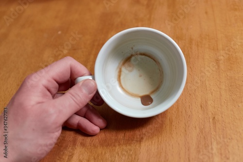 Looking inside an empty coffee cup with just leftover drops