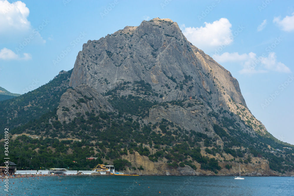 Sudak, New World, Russia - July 29, 2016: Mount Sokol, promenade with a beach. The coast of the black sea.