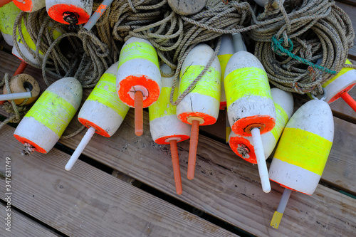 Colorful lobster floats decorate a wooden lobstrermans dock on the Maine Coast photo