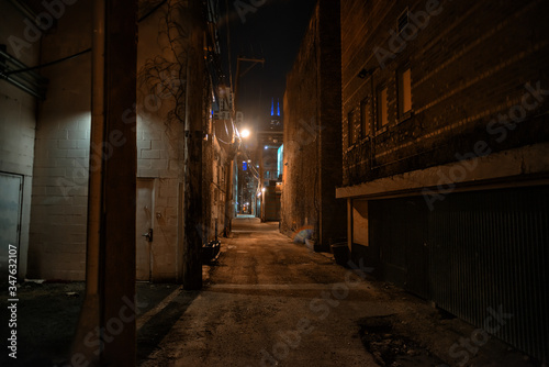 Dark and eerie urban city alley at night