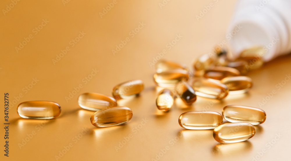Many capsules Omega 3 on yellow background. Close up, high resolution product. Health care concept. Many capsules Omega 3 on yellow background. Close up, high resolution product. Health care concept.