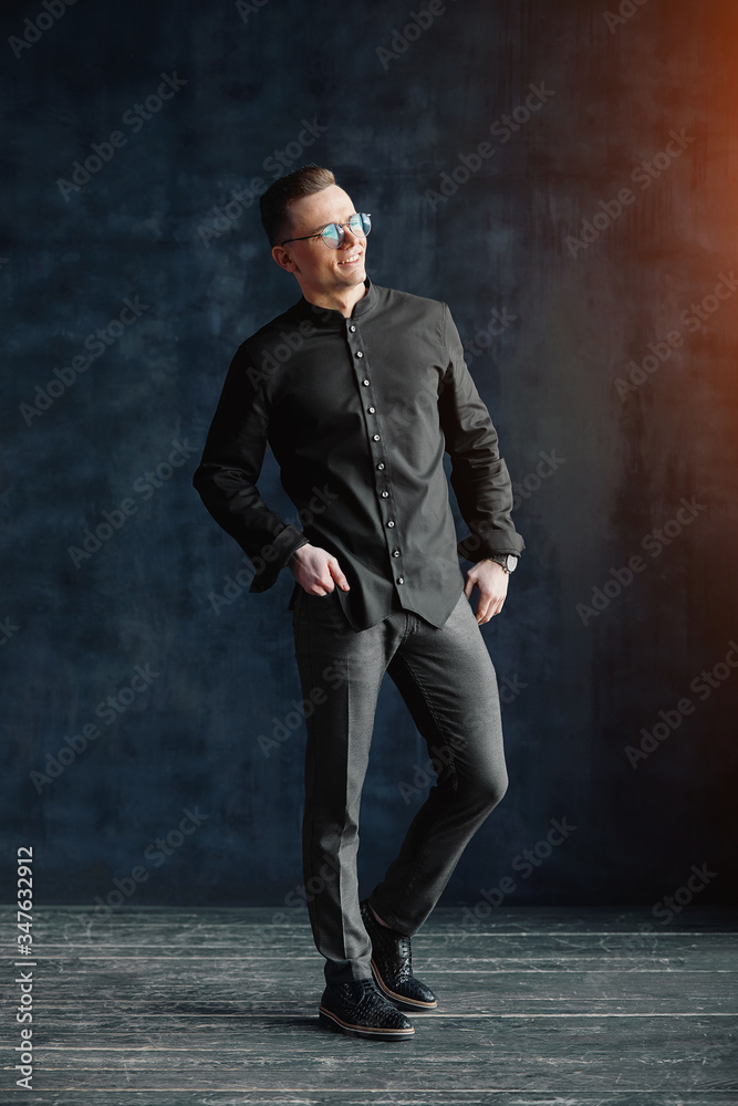 A pensive man in a stylish shirt in good physical shape looks at the camera. Be confident in yourself, not be afraid of the environment. A pensive man in a stylish shirt in good physical shape looks at the camera. Be confident in yourself, not be afraid of the environment.