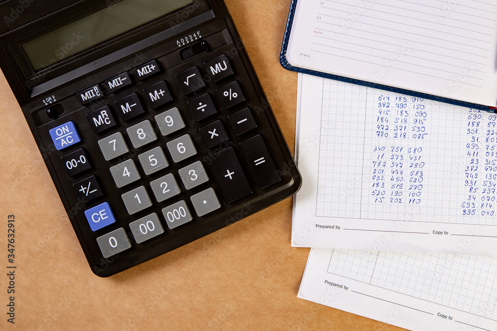 Flat lay of calculator with dairy and documents on the table. Flat lay of calculator with dairy and documents on the table.
