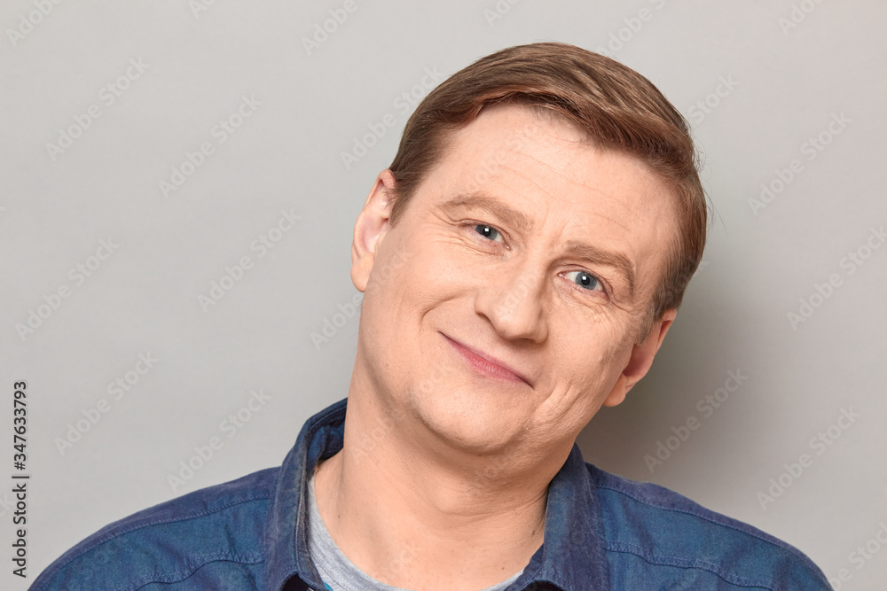 Portrait of blond mature man with happy expression and smiling