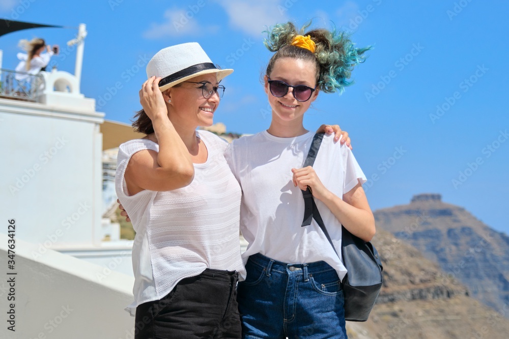 Two happy smiling women, mother and teenage daughter traveling together