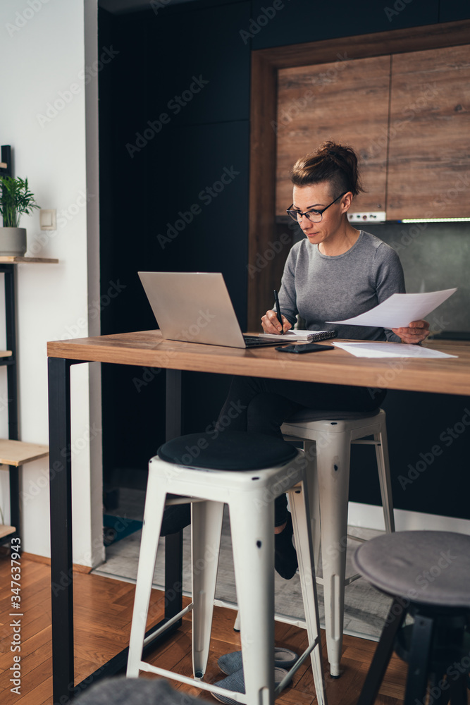 Business woman reading reports at home Business woman reading reports at home