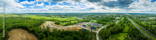 Aerial panorama of large construction site of a new single family home and town house neighborhood in the middle of a golf course in Turf Valley Maryland with home sites and triplexes © tamas