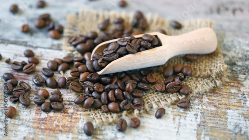 Selective focus. Wooden spatula with grains of coffee. Coffee beans.