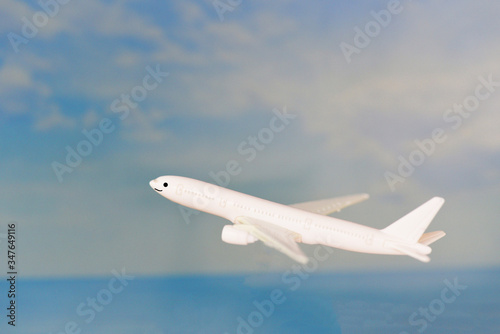 Airplane flying in the blue sky with - Traveler's Airlines plane toy