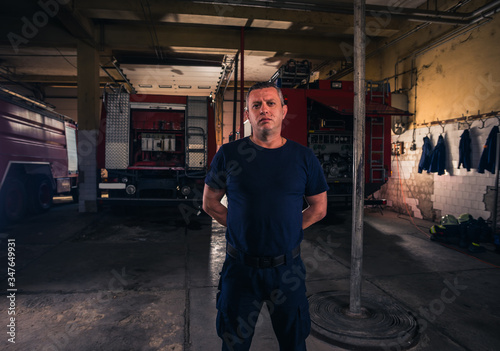 Portrait of fireman standing inside the fire department
