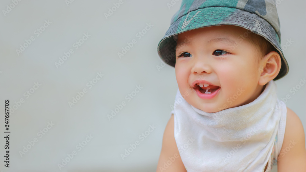 Close-up of Asian adorable toddler kid in good mood smiling happily and relaxed with copy space. Baby care and childhood concept. Close-up of Asian adorable toddler kid in good mood smiling happily and relaxed with copy space. Baby care and childhood concept.