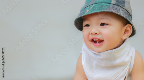 Close-up of Asian adorable toddler kid in good mood smiling happily and relaxed with copy space. Baby care and childhood concept.