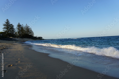 Beach in Australia, surf, calm reflection, sunset and sand. © Inzion Designs