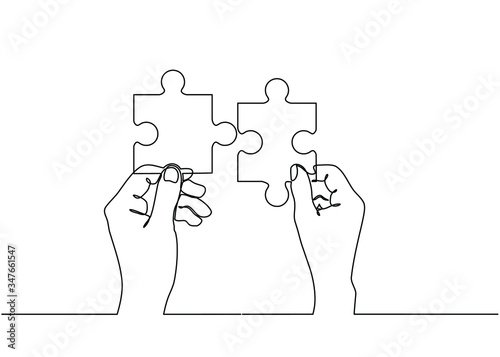 Continuous line drawing of hands solving Two Puzzle Pieces. Concept of business teamwork and integration with puzzle. Teamwork and partnership concept of two businessman isolated on white background.