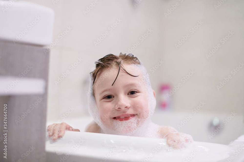 little girl in bath playing with soap foam little girl in bath playing with soap foam