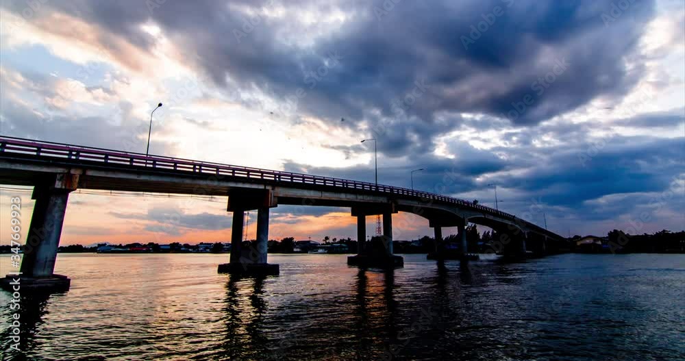 Timelapse rain clouds flowed and gathered  ,Above the bridge over the river , Moving slowly, beautifully, evening light in Thailand