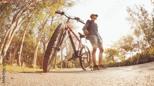 Cyclist with mountain bike at park.