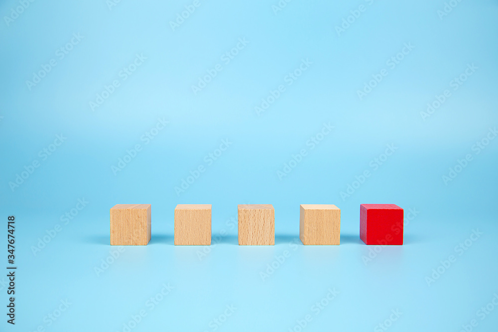 Cube shape wooden block toy stacked without graphics with blue background for Business design concept and activity for child foundation practice skills.