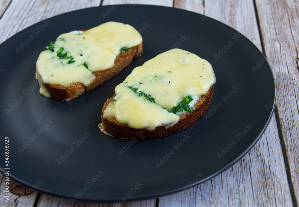 Sandwich with egg, melted cheese and herbs Sandwich with egg, melted cheese and herbs