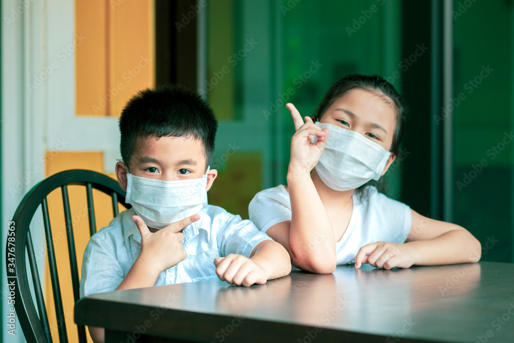 asian children wearing protection mask quarantine at home white covid-19 infected in bangkok thailand