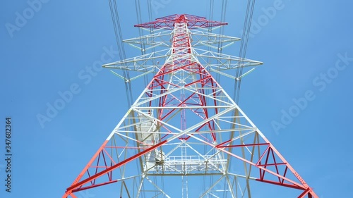 4K Prores of  red and white color high voltage pole and blue sky, panning and rolling