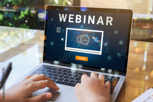 Person using a laptop computer for online training webinars. E-learning browsing connection and cloud online technology webcast concept. Laptop mockup with clipping path on screen.