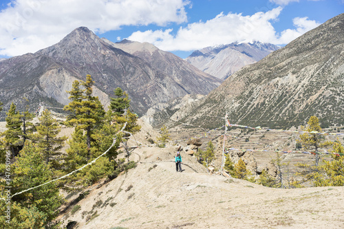 Travel and trekking concept. Woman with backpack on trekking trail in himalayas mountains. Nepal.