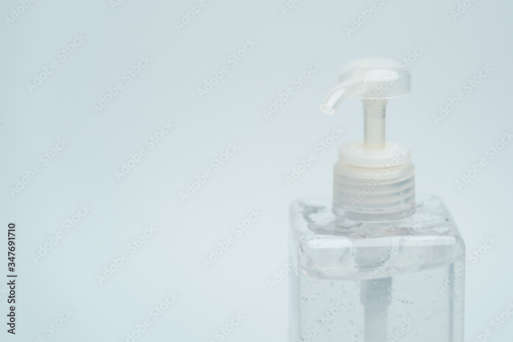 Clear hand sanitizer in a clear pump bottle on a white background. Clear hand sanitizer in a clear pump bottle on a white background.